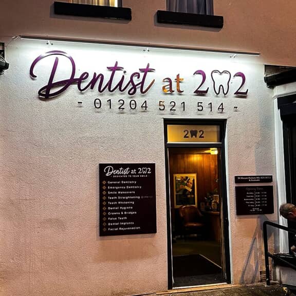 An image of dental outdoor channel letter signage at night.